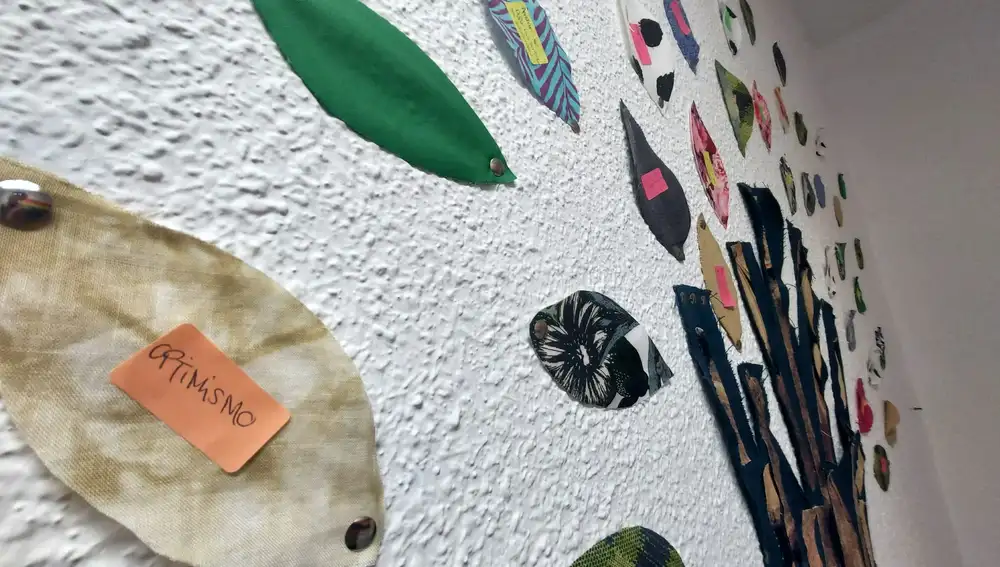 Un cartel sobre una hoja de papel reza "optimismo" en un mural hecho por los jóvenes entre 12 y 22 años que acuden al centro de ASPA en Hortaleza.