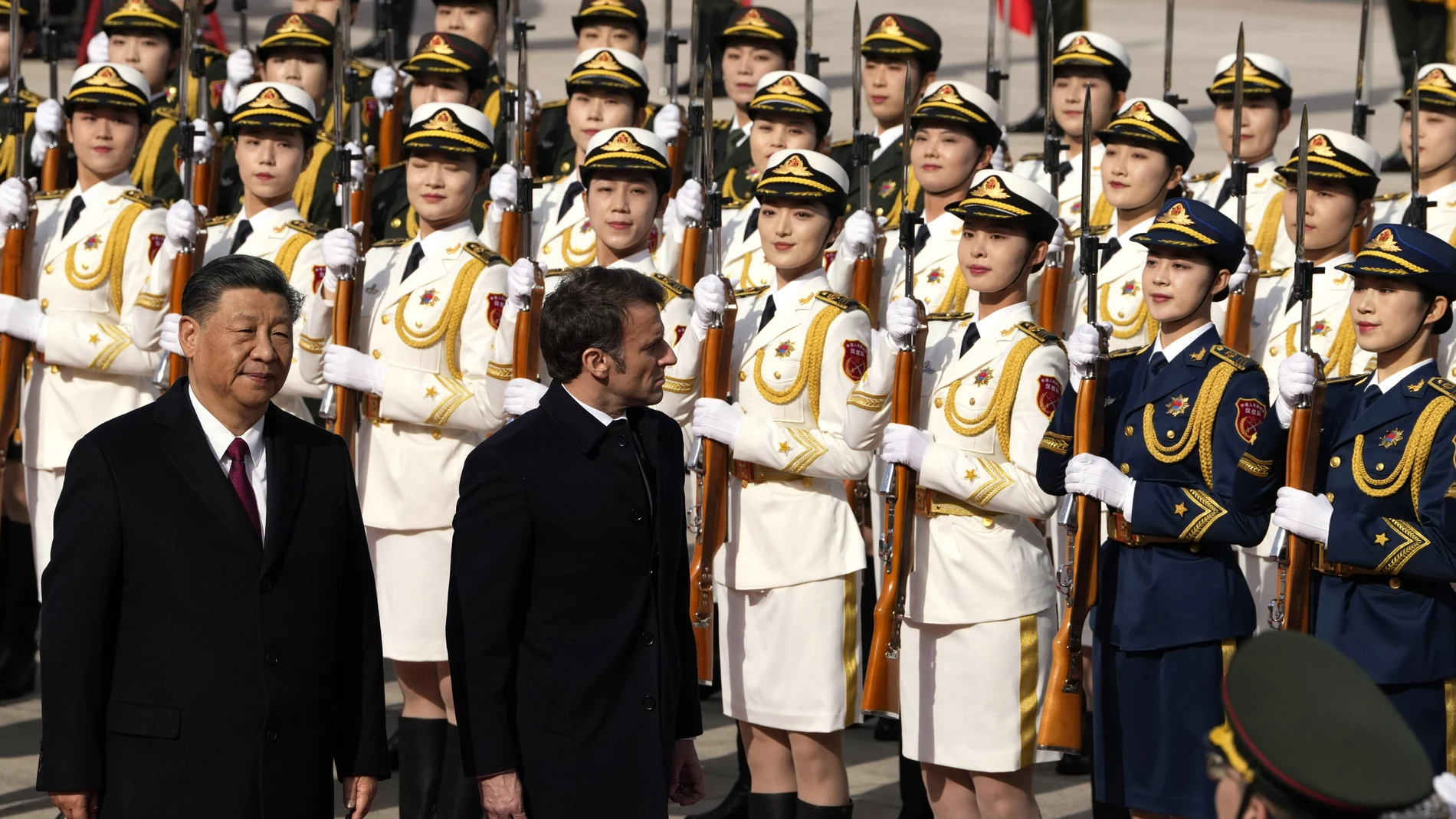 French President Emmanuel Macron, second from left, inspects an honor guard with Chinese President Xi Jinping outside the Great Hall of the People in Beijing, Thursday, April 6, 2023
