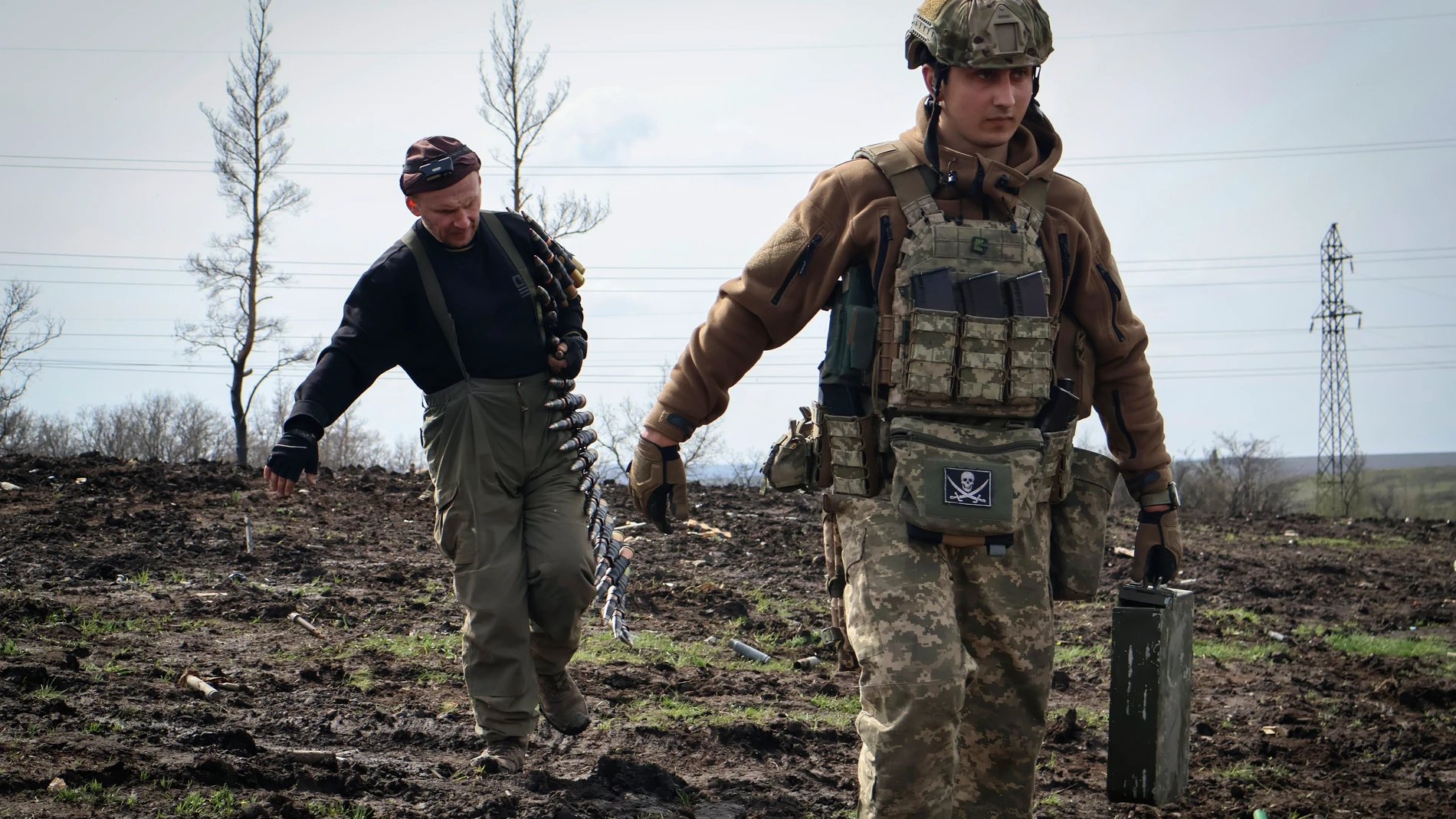 Ukrainian soldiers carry cartridges in their position on the frontline, near Bakhmut, Donetsk region, Ukraine, Friday, April 7, 2023. (Roman Chop via AP)
