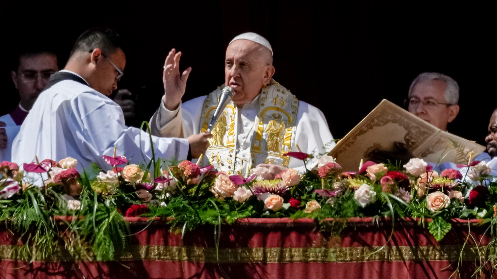 Pope Francis bestows the plenary 'Urbi et Orbi' (to the city and to the world) blessing from the central lodge of the St. Peter's Basilica at The Vatican at the end of the Easter Sunday mass, Sunday, April 9, 2023. (AP Photo/Alessandra Tarantino)