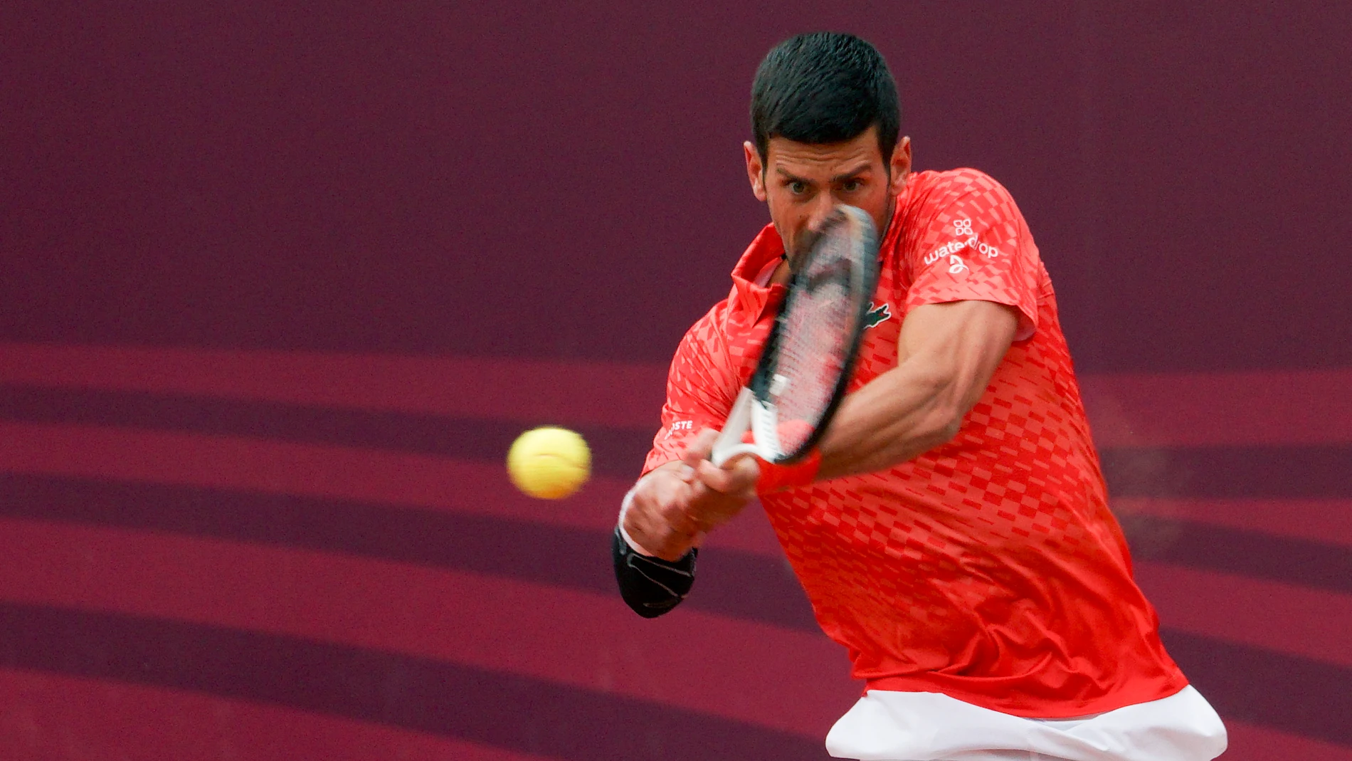 Novak Djokovic of Serbia returns a ball to Luca Van Assche of France during their tennis match of the Srpska Open tennis tournament in Banja Luka, Bosnia, Wednesday, April 19, 2023. (AP Photo/Radivoje Pavicic)