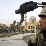 Un solado de Estados Unidos asiste al derribo de la estatua de Sadam Hussein en Bagdag