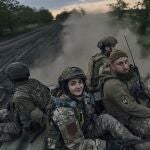 Ukrainian soldiers ride atop an APC on the frontline in the Luhansk region, Ukraine, Sunday, May 21, 2023. 