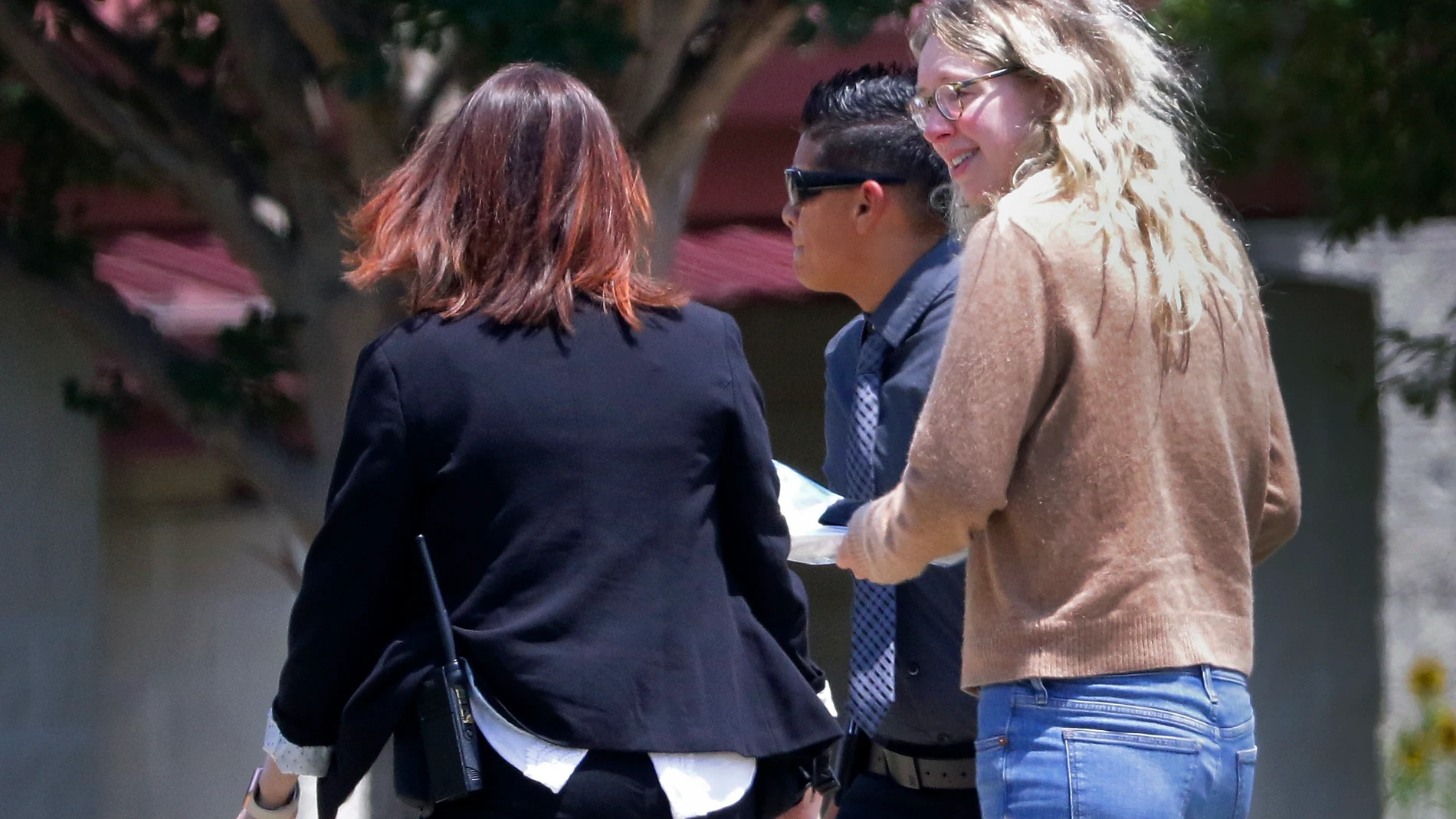 Disgraced Theranos CEO Elizabeth Holmes, right, is escorted by prison officials into a federal women’s prison camp on Tuesday, May 30, 2023, in Bryan, Texas. Holmes will spend the next 11 years serving her sentence for overseeing an infamous blood-testing hoax. (AP Photo/Michael Wyke)