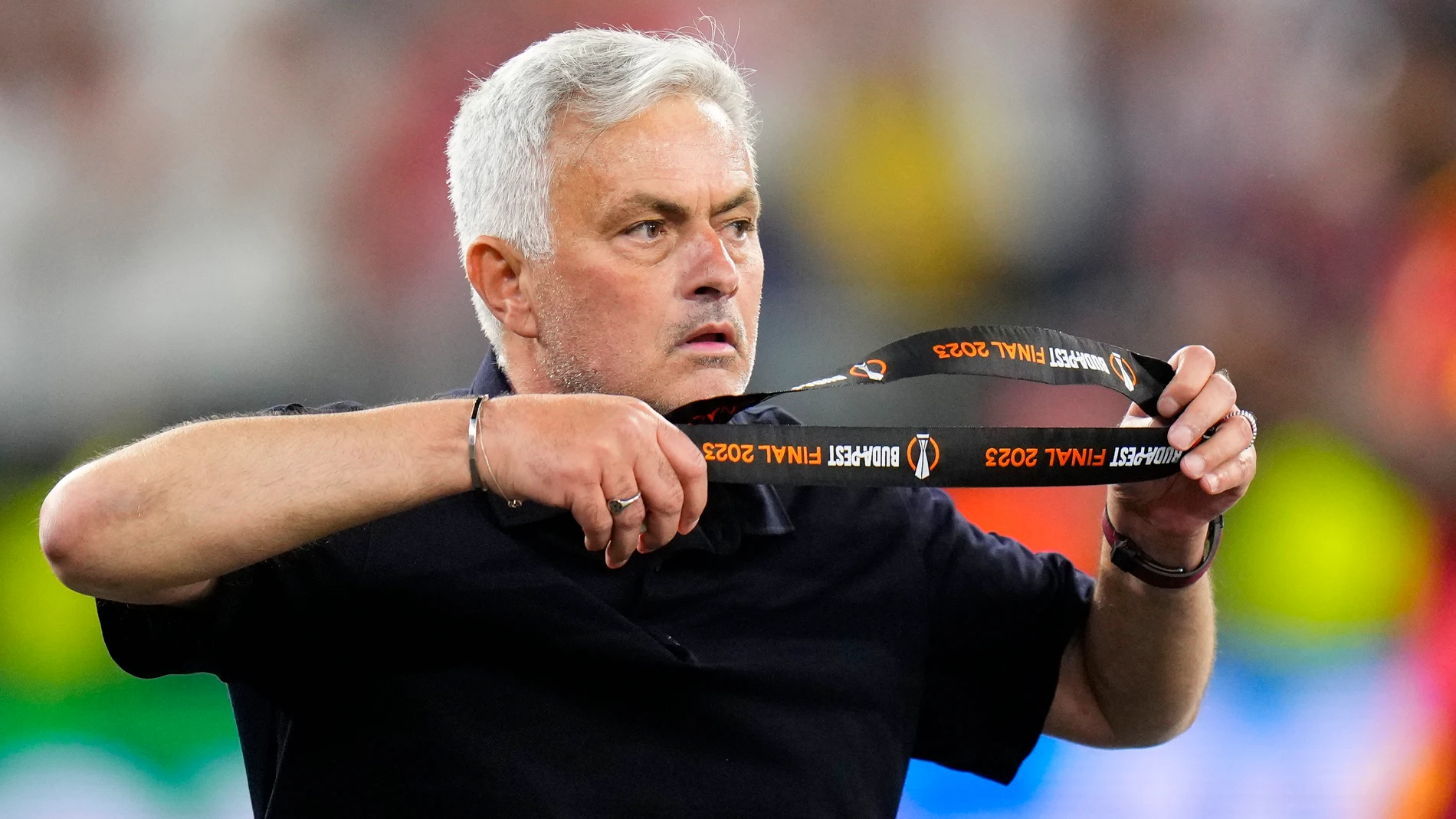 Roma's head coach Jose Mourinho takes off his second place medal after receiving it at the end of the Europa League final soccer match between Sevilla and Roma, at the Puskas Arena in Budapest, Hungary, Wednesday, May 31, 2023. Sevilla defeated Roma 4-1 in a penalty shootout after the match ended tied 1-1. (AP Photo/Petr David Josek)