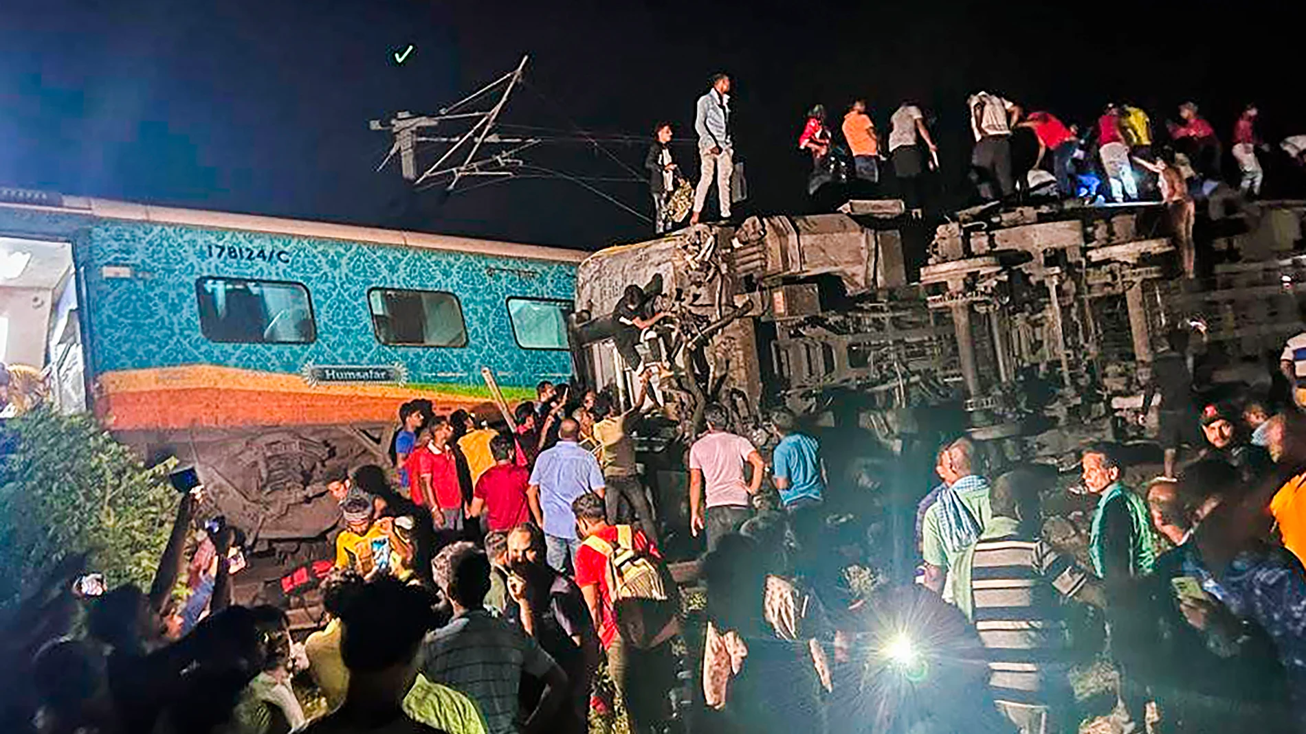 MANDATORY CREDIT- Rescuers work at the site of passenger trains that derailed in Balasore district, in the eastern Indian state of Orissa, Friday, June 2, 2023. Two passenger trains derailed in India, killing at least 13 people and trapping hundreds of others inside more than a dozen damaged coaches, officials said. About 400 people were injured and taken to hospitals, and the cause of the accident was under investigation, officials said. (Press Trust of India via AP)