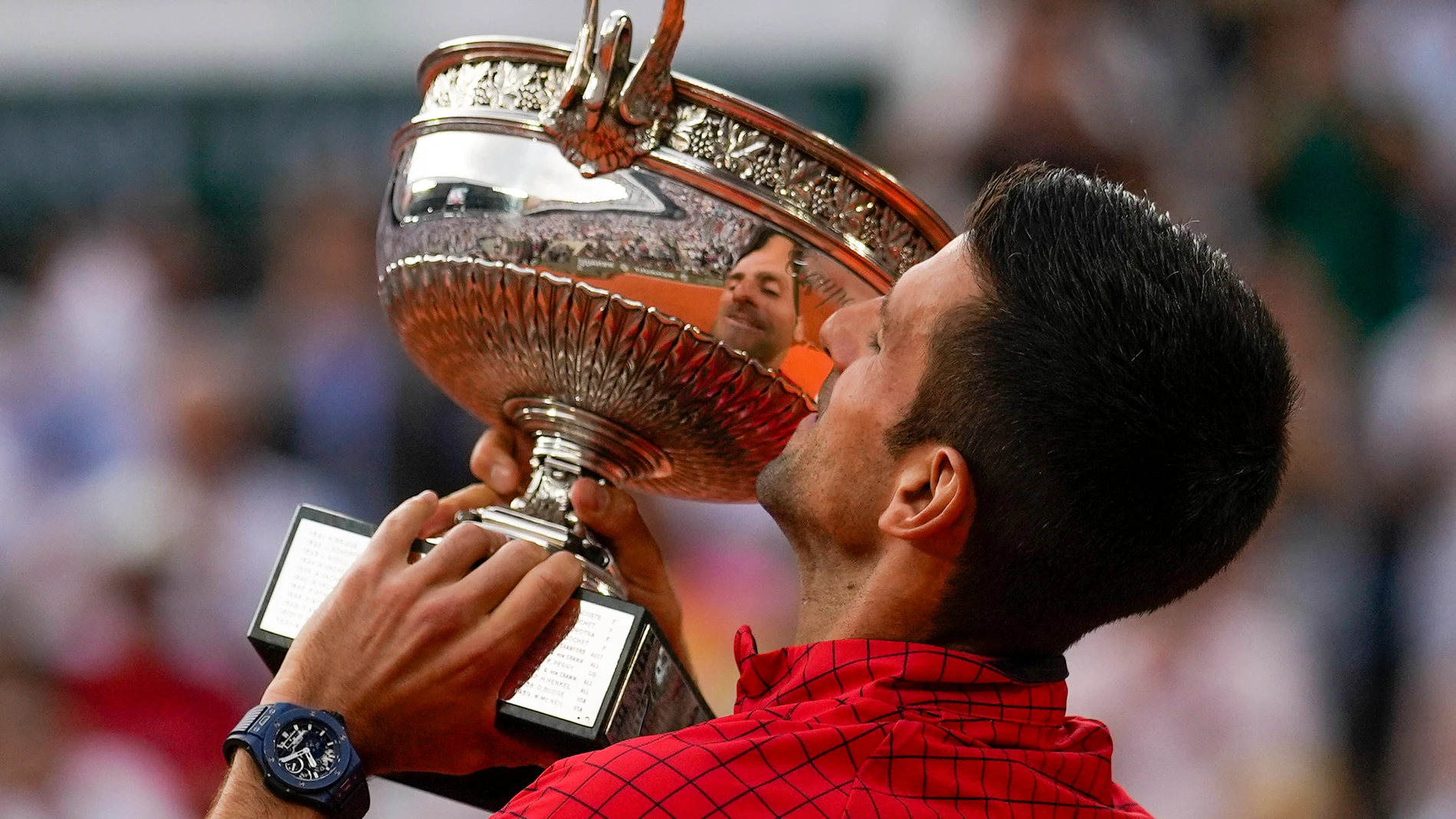 Serbia's Novak Djokovic holds the trophy as he celebrates winning the men's singles final match of the French Open tennis tournament against Norway's Casper Ruud in three sets, 7-6, (7-1), 6-3, 7-5, at the Roland Garros stadium in Paris, Sunday, June 11, 2023. Djokovic won his record 23rd Grand Slam singles title, breaking a tie with Rafael Nadal for the most by a man. (AP Photo/Thibault Camus)
