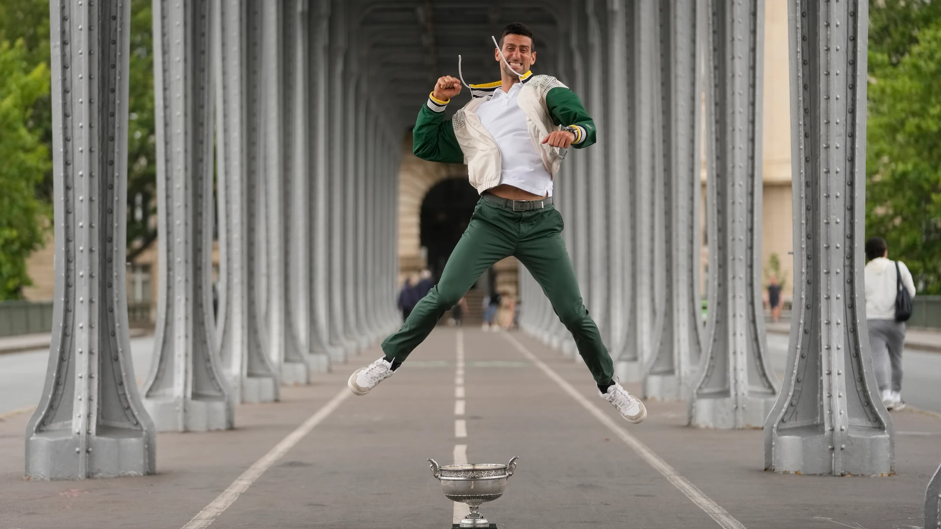 Serbia's Novak Djokovic jumps by his trophy one day after winning the French Open tennis tournament in Paris, Monday, June 12, 2023. Novak Djokovic returned to No. 1 in the ATP rankings on Monday, replacing Carlos Alcaraz there, after winning the French Open for a men's-record 23rd Grand Slam title.(AP Photo/Thibault Camus)