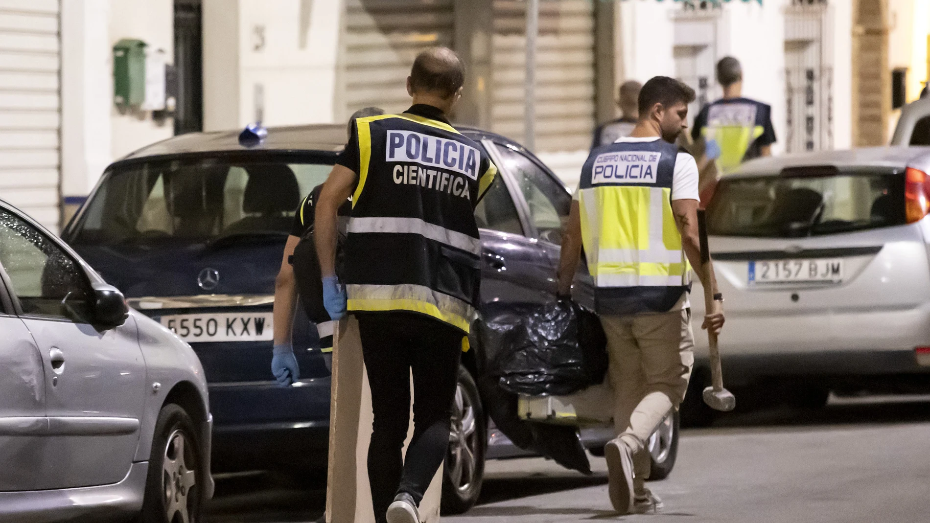 Varios miembros de la Policía Nacional abandonando el lugar de los hechos tras sacar el cuerpo sin vida de Sibora Gagani