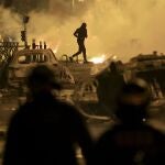 A demonstrator runs on the third night of protests sparked by the fatal police shooting of a 17-year-old driver in the Paris suburb of Nanterre, France, Friday, June 30, 2023. The June 27 shooting of the teen, identified as Nahel, triggered urban violence and stirred up tensions between police and young people in housing projects and other neighborhoods. 