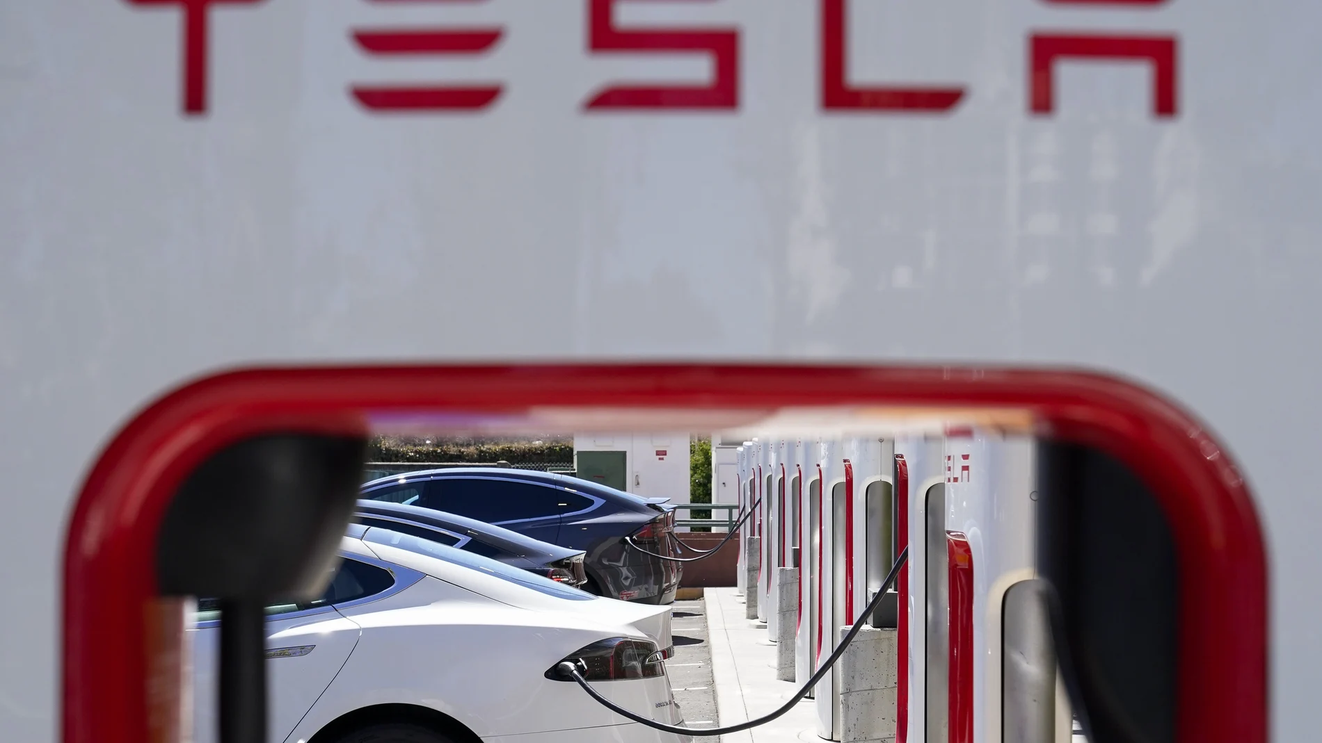 Tesla vehicles charge at a station in Emeryville, Calif.