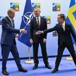 Turkish President Recep Tayyip Erdogan (L) shakes hands with Swedish Prime Minister Ulf Kristersson (R) as the Secretary General of NATO Jens Stoltenberg (C) looks on during their meeting ahead of the NATO summit in Vilnius, Lithuania, 10 July 2023.