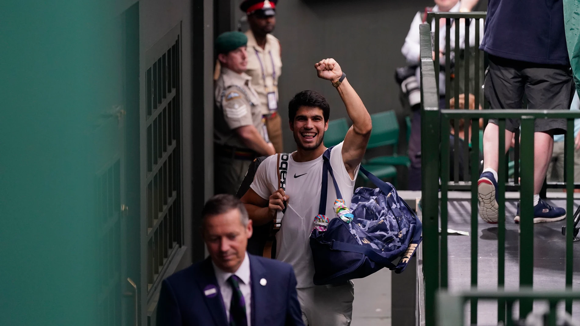 Spain's Carlos Alcaraz celebrates after beating Russia's Daniil Medvedev as he leaves the court after their men's singles semifinal match on day twelve of the Wimbledon tennis championships in London, Friday, July 14, 2023. (AP Photo/Alberto Pezzali)
