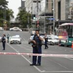 Armed New Zealand police officers stand at a road block in the central business district following a shooting in Auckland, New Zealand