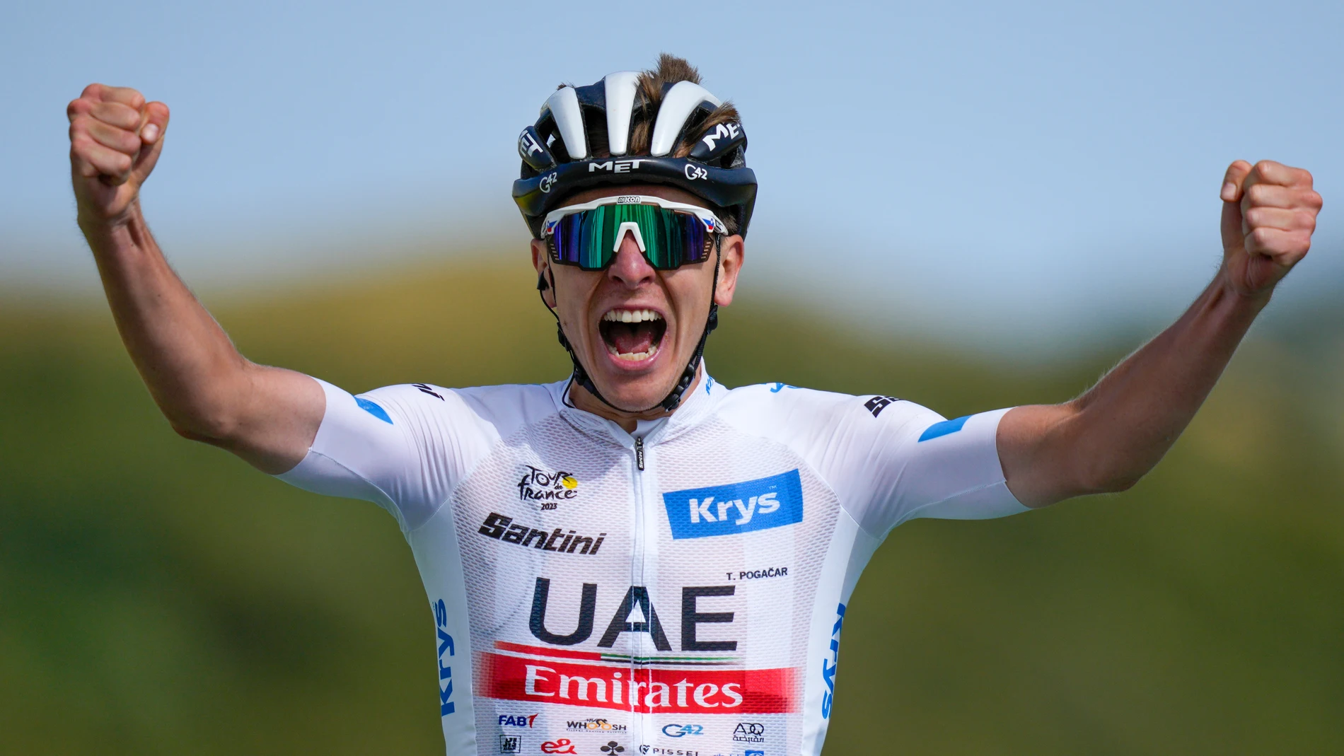 Slovenia's Tadej Pogacar, wearing the best young rider's white jersey, celebrates as he crosses the finish line to win the twentieth stage of the Tour de France cycling race over 133.5 kilometers (83 miles) with start in Belfort and finish in Le Markstein Fellering, France, Saturday, July 22, 2023. (AP Photo/Daniel Cole)