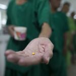Patients line up to receive medicine in a rehabilitation program.