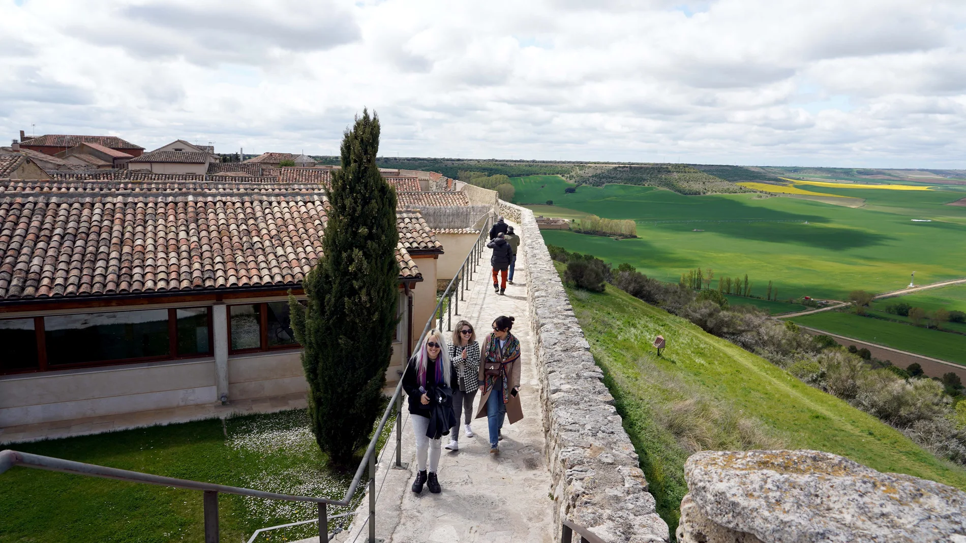 Turistas recorren las murallas de la localidad vallisoletana de Urueña, la Villa del Libro