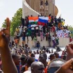 People display a Russia and a Niger flags outside the National Assembly building during a protest in Niamey, Niger, 30 July 2023. 