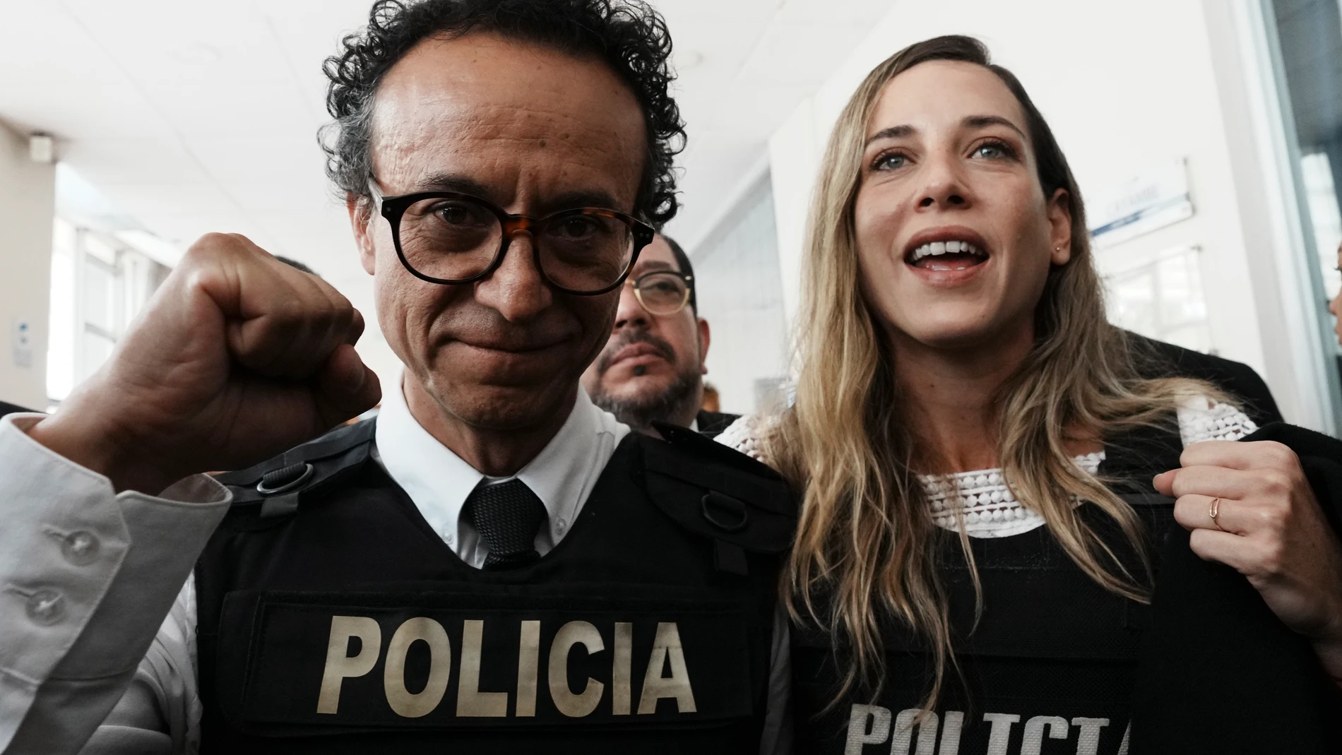 Christian Zurita raises his fist during a press conference to announce he was nominated by the Movimiento Construye to replace slain Fernando Villavicencio as presidential candidate in Quito, Ecuador, Sunday, Aug. 13, 2023. At left is vice-presidential candidate Andrea Gonzalez. Villavicencio was fatally shot at a political rally on Aug. 9 in Quito. (AP Photo/Dolores Ochoa)