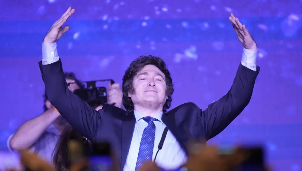 Javier Milei, presidential candidate of the Liberty Advances coalition, raises his arms at his campaign headquarters after polling stations closed during primary elections in Buenos Aires, Argentina, Sunday, Aug. 13, 2023.
