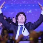 Javier Milei, presidential candidate of the Liberty Advances coalition, raises his arms at his campaign headquarters after polling stations closed during primary elections in Buenos Aires, Argentina, Sunday, Aug. 13, 2023. 
