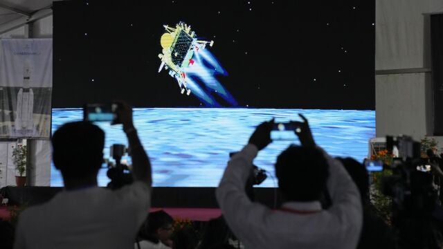 Journalists film the live telecast of spacecraft Chandrayaan-3 landing on the moon at ISRO's Telemetry, Tracking and Command Network facility in Bengaluru, India, Wednesday, Aug. 23, 2023. India lands a spacecraft near the moonís south pole, becoming the fourth country to touch down on the lunar surface. (AP Photo/Aijaz Rahi)