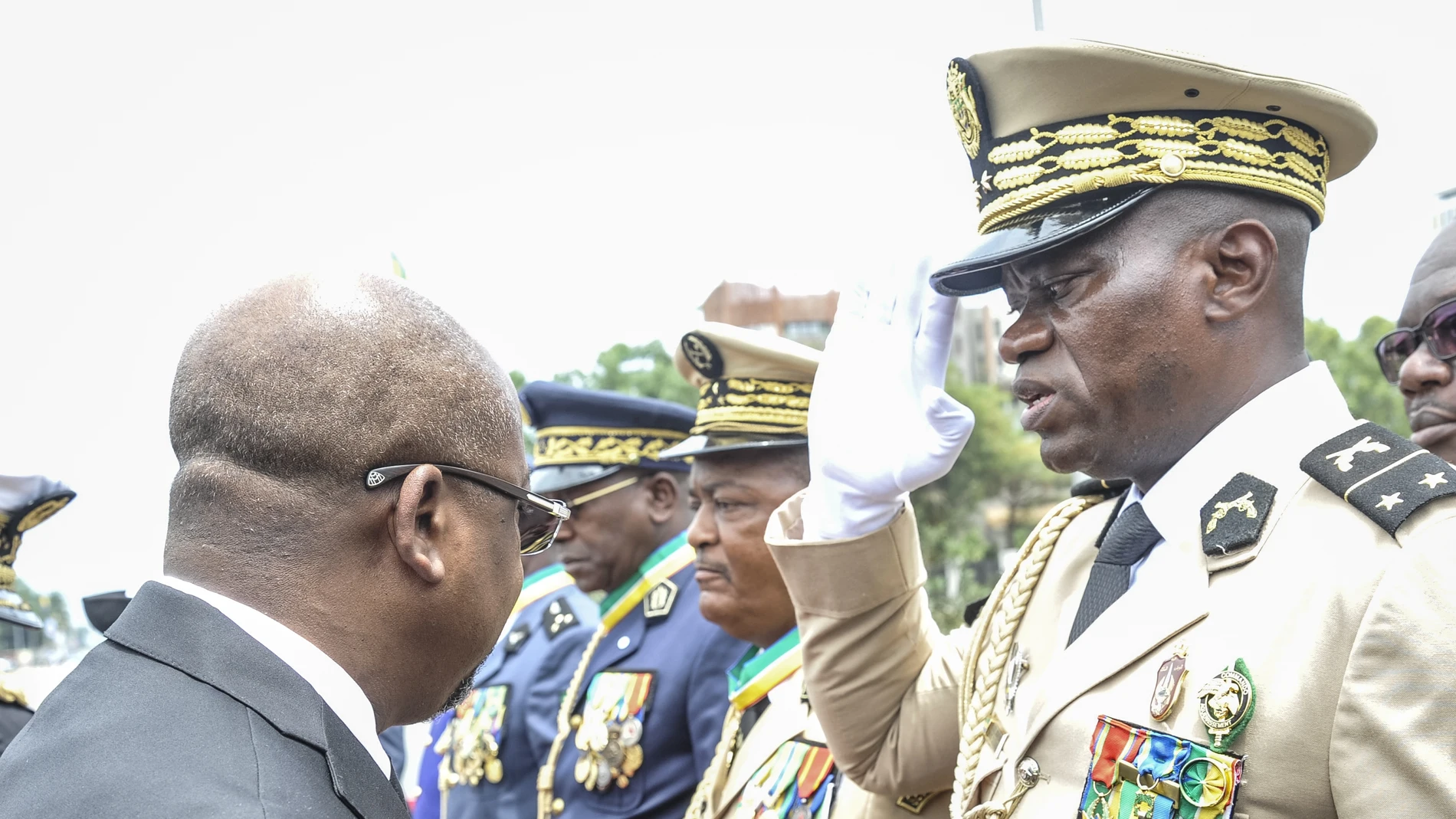 Head of Gabon's elite Republican Guard, General Brice Oligui Nguema (R), is decorated by Gabon Prime Minister Alain Claude Bilie Bie Nze (L) in Libreville on August 16, 2023 during celebrations ahead of Gabon Independence day celebrated on August 17, 2023.