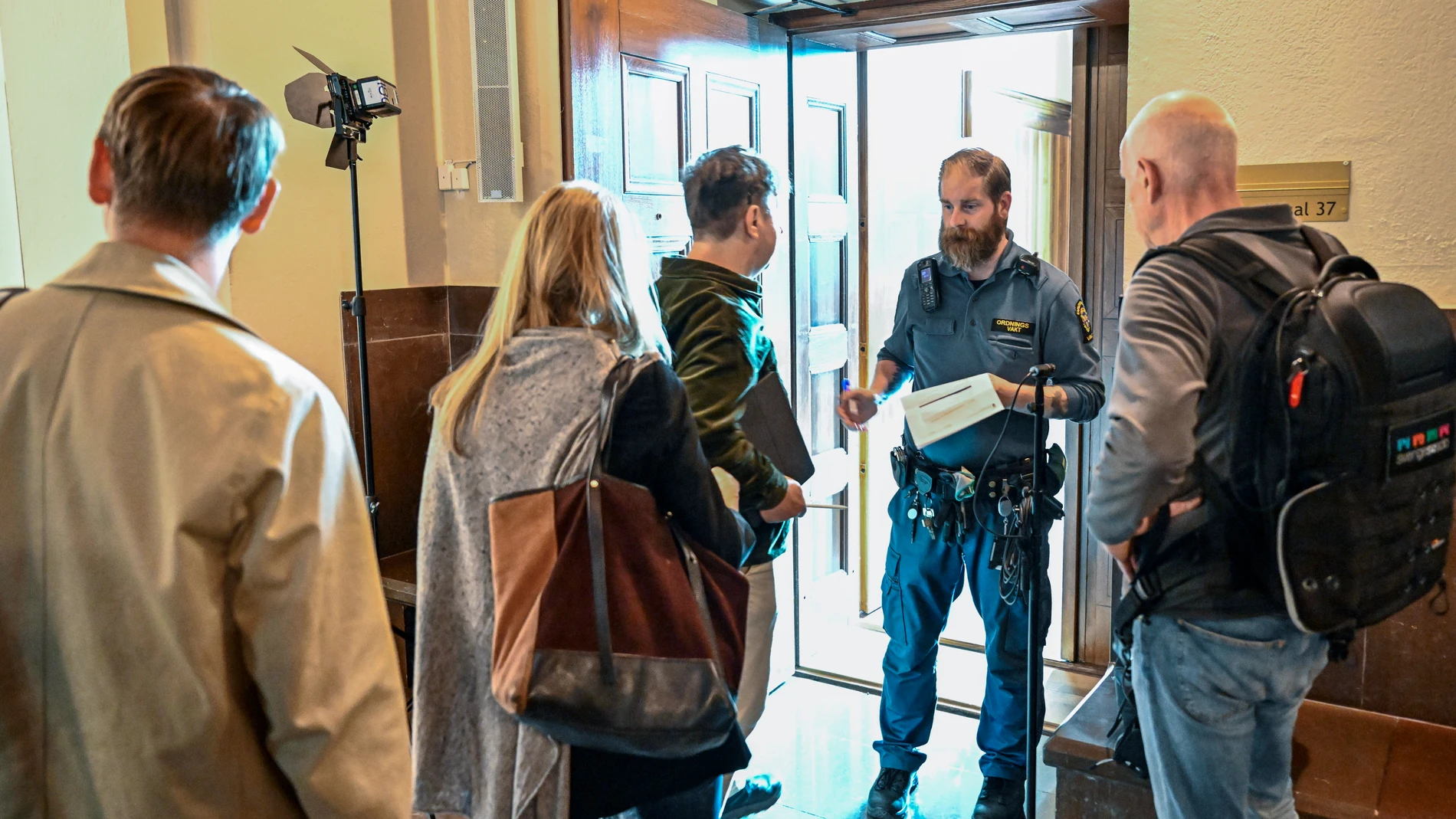 People wait outside a courtroom at the Stockholm District Court for the trial of a Russian-born Swedish citizen charged with collecting information for the Russian military intelligence service GRU for almost a decade, in Stockholm, Monday, Sept. 4, 2023. Sergey Skvortsov is accused of “gross illegal intelligence activities against Sweden and against a foreign power,” according to prosecutor Henrik Olin. (Jonas Ekstromer/TT News Agency via AP)
