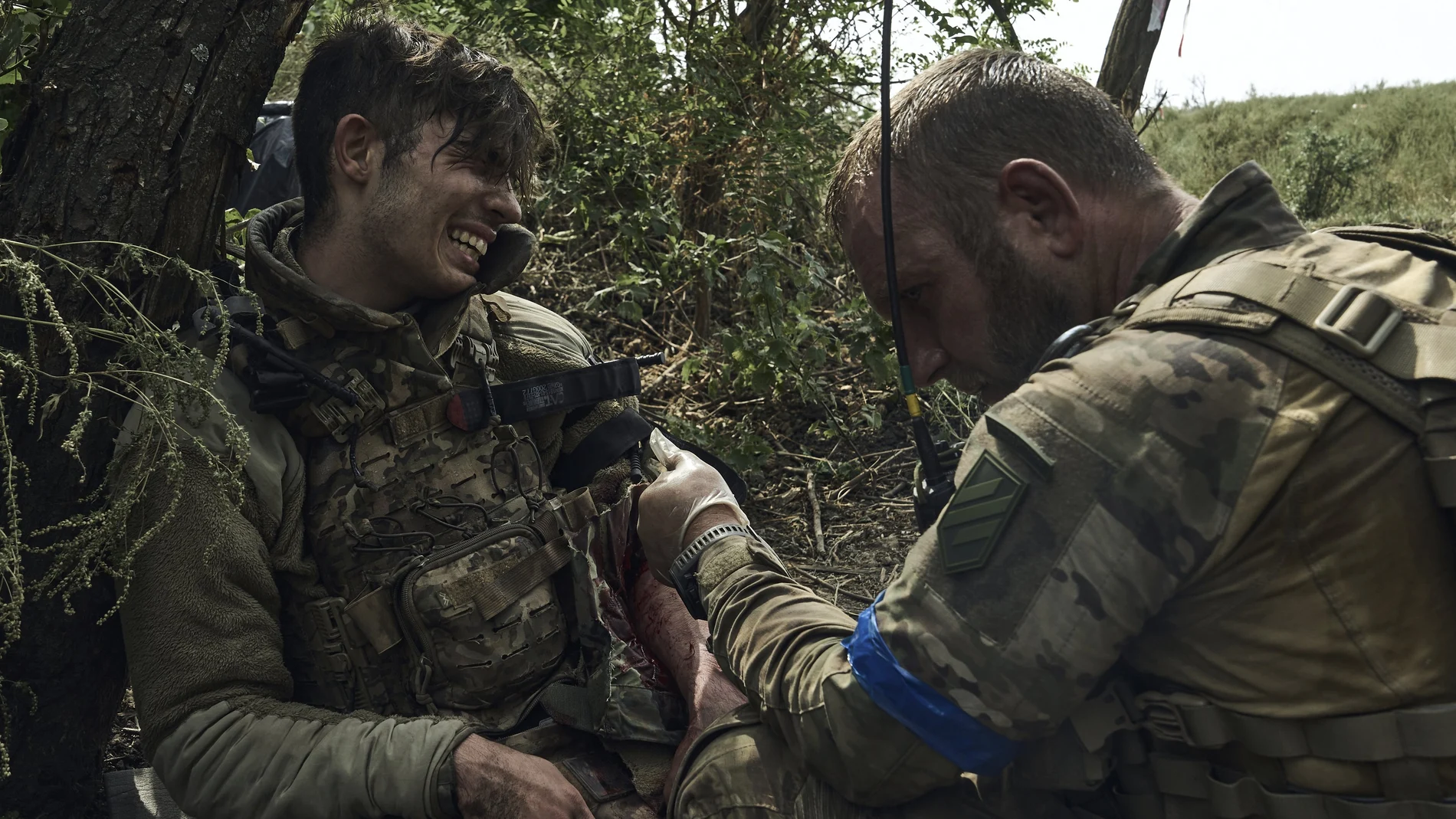 A soldier of Ukraine's 3rd Separate Assault Brigade gives first aid to his wounded comrade, call sign Polumya (Flame), 19, near Bakhmut, the site of fierce battles with the Russian forces in the Donetsk region, Ukraine, Monday, Sept. 4, 2023.