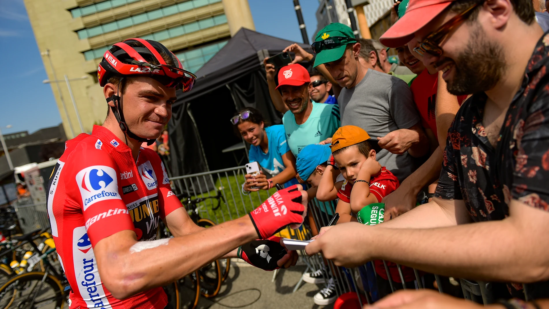 Jumbo Visma's Sepp Kuss, signs autographs before the start of the thirteen stage of La Vuelta between Pamplona and Lekunberri, 158,5 km (98.4 miles) in Pamplona, northern Spain, Sunday Sept. 10, 2023. (AP Photo/Alvaro Barrientos)