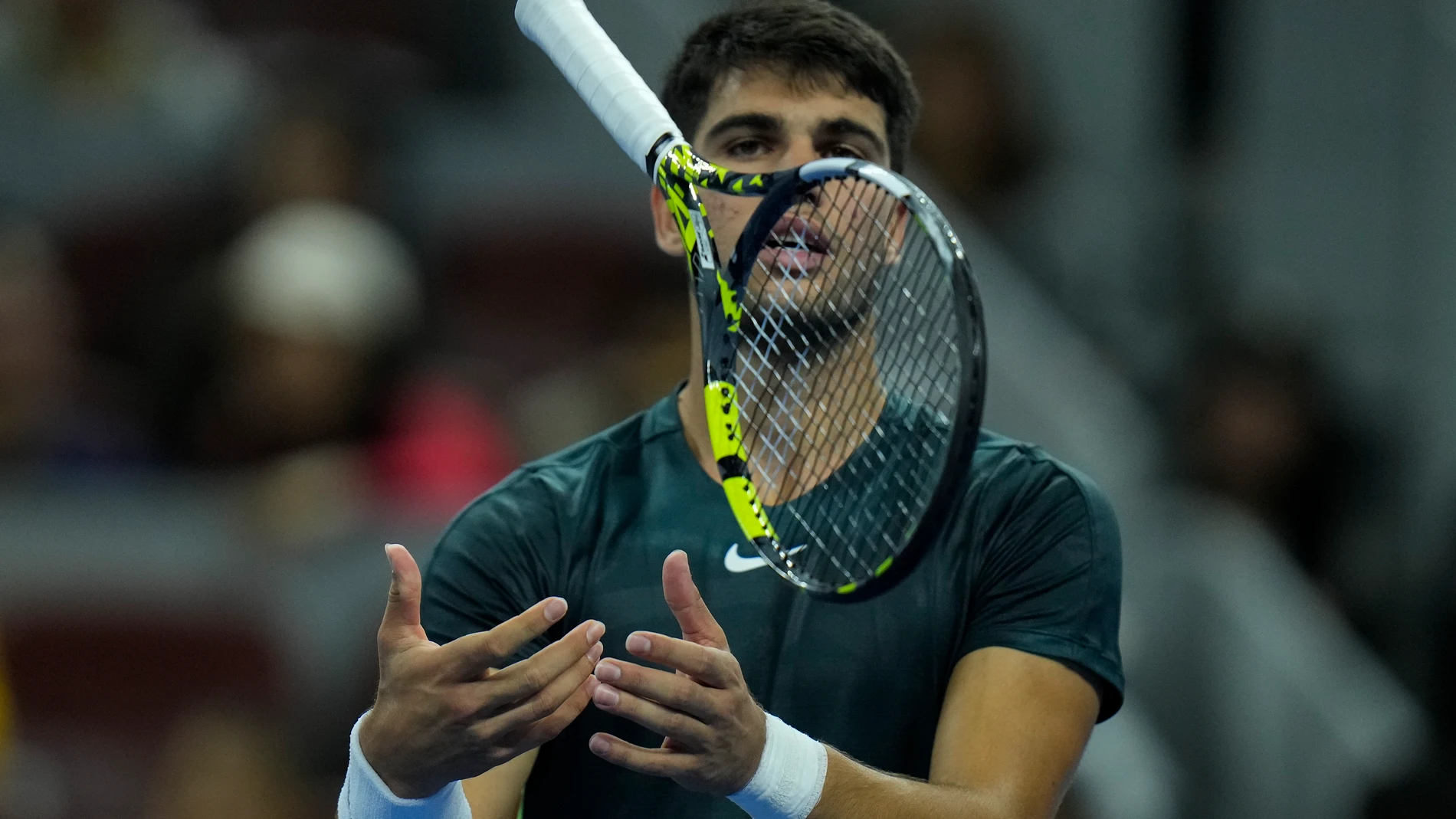 Carlos Alcaraz of Spain throws his racquet after losing a point to Jannik Sinner of Italy during the men's singles semifinal match in the China Open tennis tournament at the Diamond Court in Beijing, Tuesday, Oct. 3, 2023. (AP Photo/Andy Wong)