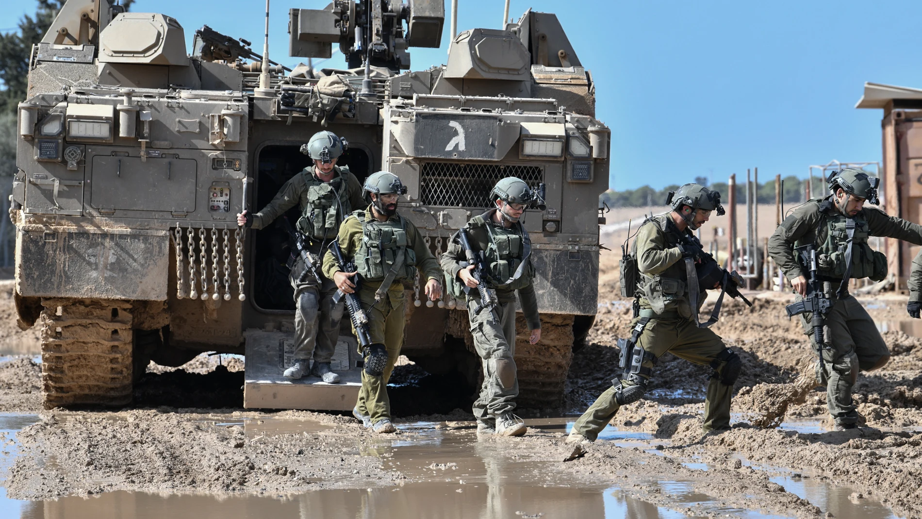SDEROT, Oct. 14, 2023 -- This photo taken on Oct. 13, 2023 shows Israeli soldiers disembarking from an armored vehicle near the Israel-Gaza border, in southern Israel. The Israel Defense Forces (IDF) on Friday ordered residents of populous Gaza City to evacuate southward in 24 hours. Following the call, which drew wide condemnation, the IDF revealed it had launched ground "localized raids" into the besieged Palestinian enclave. 13/10/2023