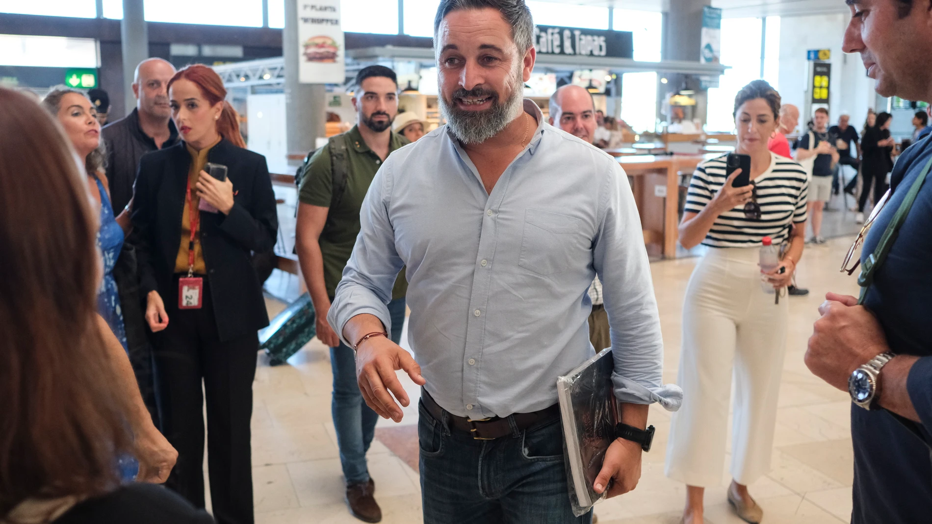 LA LAGUNA (TENERIFE), 19/10/2023.- El presidente de Vox, Santiago Abascal, ha defendido este jueves el bloqueo de las rutas marítimas para atajar la llegada de embarcaciones con inmigrantes a las costas canarias, para lo cual considera que España cuenta con medios como la Armada. En la imagen, Abascal (c) hace escala en el aeropuerto de Tenerife Norte tras visitar la isla de El Hierro, para conocer la situación con la llegada de cayucos. EFE/Alberto Valdés