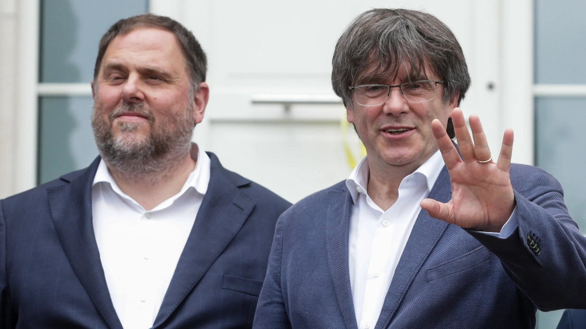 Free Catalan separatist leaders Oriol Junqueras (L) is welcomed by Former Catalan leader Carles Puigdemont ahead of a meeting at Casa de la Republica Catalana in Waterloo.