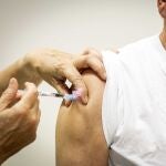 An elderly person receives a dose of coronavirus disease (COVID-19) vaccine.