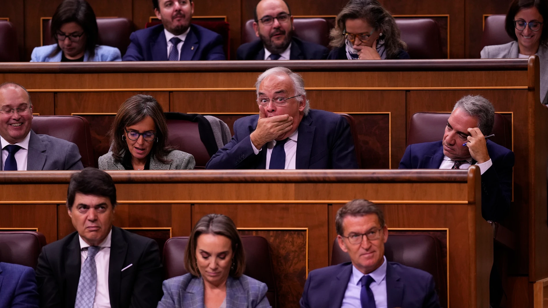 Euro Deputy from the Popular Party Esteban Gonzalez Pons, centre, reacts to Spain's acting Prime Minister Pedro Sanchez speech as Spain conservative opposition leader Alberto Nunez Feijoo, bottom right, listens to the proceedings during the investiture debate at the Spanish Parliament in Madrid, Spain, Wednesday, Nov. 15, 2023. Spain's acting Prime Minister Pedro Sanchez will defend his controversial amnesty deal for Catalonia's separatists in parliament by midday Wednesday as part of a debat...