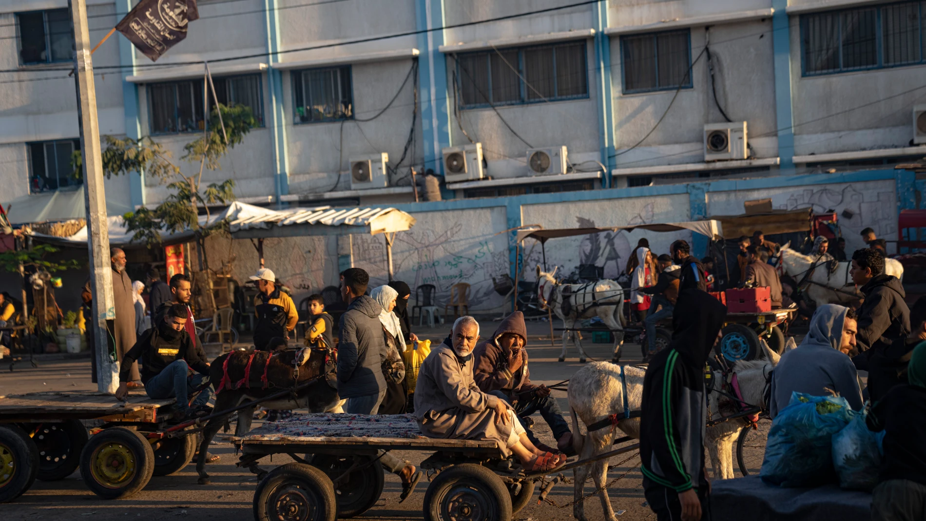 Palestinians ride donkey carts during the ongoing Israeli bombardment of the Gaza Strip in Khan Younis on Friday, Nov. 17, 2023. (AP Photo/Fatima Shbair)