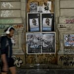 A man walks near a posters of Sergio Massa, Argentine Economy Minister and presidential candidate for the ruling party, in Buenos Aires, Argentina, Saturday, Nov. 18, 2023. Massa will face Liberty Advances coalition candidate Javier Milei in a runoff election on Nov. 19. (AP Photo/Rodrigo Abd)