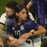 Argentina's Lionel Messi sits with his wife Antonela Roccuzzo after Argentina won the World Cup final soccer match against France at the Lusail Stadium in Lusail, Qatar