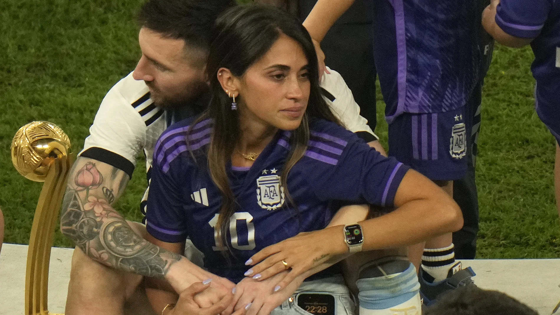 Argentina's Lionel Messi sits with his wife Antonela Roccuzzo after Argentina won the World Cup final soccer match against France at the Lusail Stadium in Lusail, Qatar