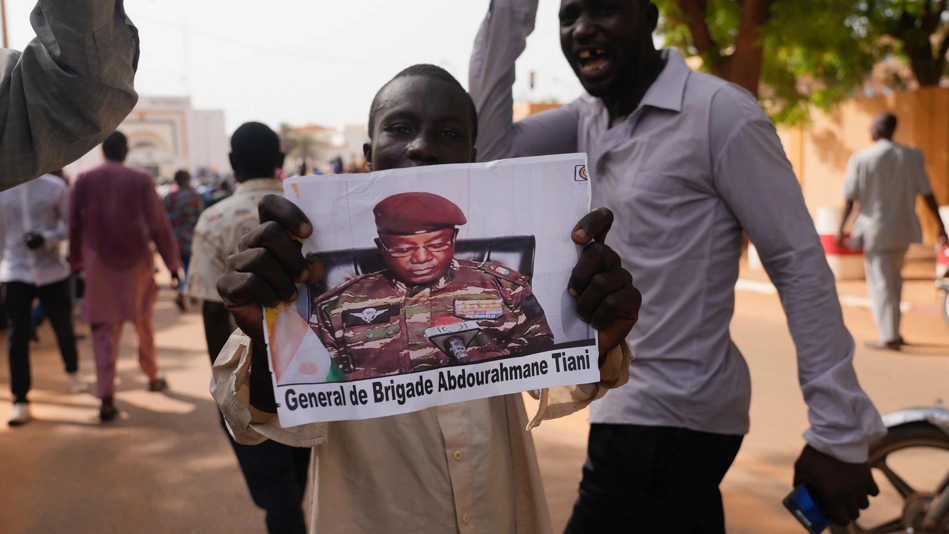 FILE - Nigeriens participate in a march called by supporters of coup leader Gen. Abdourahmane Tchiani, pictured, in Niamey, Niger, July 30, 2023. Niger’s junta has signed a decree revoking a 2015 law that was enacted to curb the smuggling of migrants traveling from African countries through a key migration route in Niger en route to Europe, according to a government circular issued on Monday, Nov. 27. “The convictions pronounced pursuant to said law and their effects shall be cancelled,” Tchi...