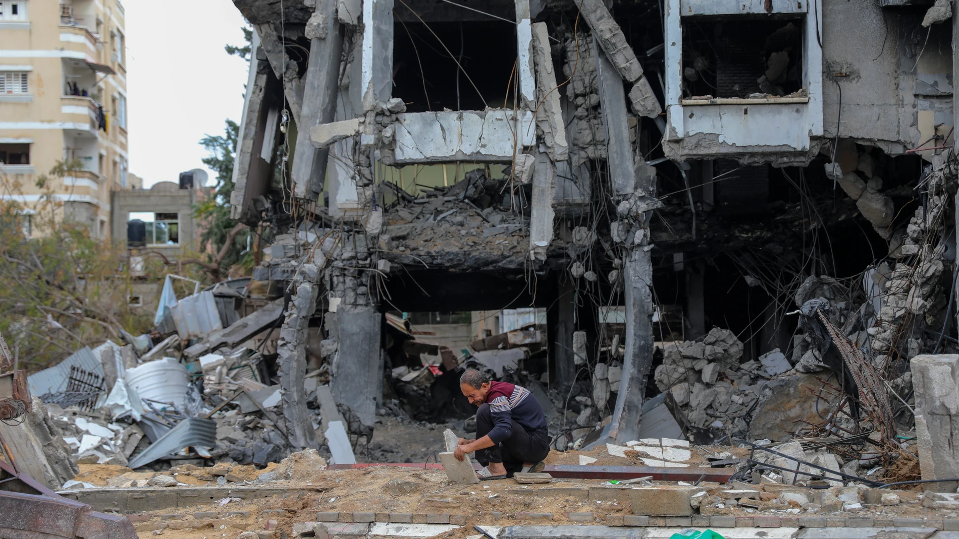 A Palestinian man works on the rubble of destroyed buildings in Beit Lahiya, Gaza Strip, Tuesday, Nov. 28, 2023. on the fifth day of the temporary ceasefire between Hamas and Israel. (AP Photo/Mohammed Hajjar)