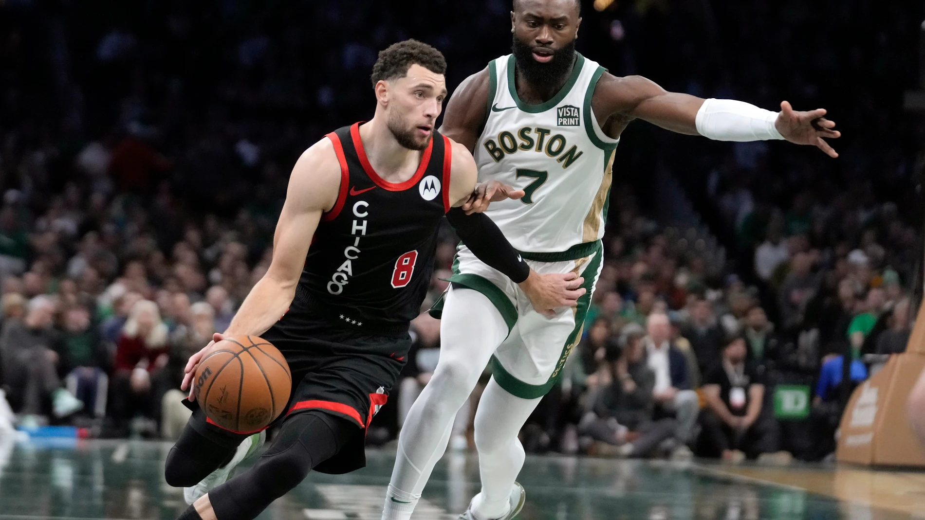 Boston Celtics center Kristaps Porzingis (8) drives toward the basket as Boston Celtics guard Jaylen Brown (7) defends during the first half of an NBA In-Season Tournament basketball game, Tuesday, Nov. 28, 2023, in Boston. (AP Photo/Steven Senne)
