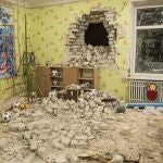 A debris mixes with toys below a damaged wall after the reported shelling on a kindergarten in the settlement of Stanytsia Luhanska, Ukraine.