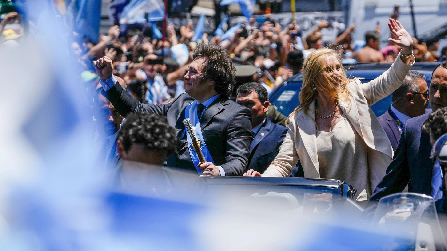 Argentina's newly sworn-in President Javier Milei and his sister Karina wave to supporters from a car heading to the government house after his swearing-in ceremony in Buenos Aires, Argentina, Sunday, Dec. 10, 2023. (AP Photo/Rodrigo Abd)
