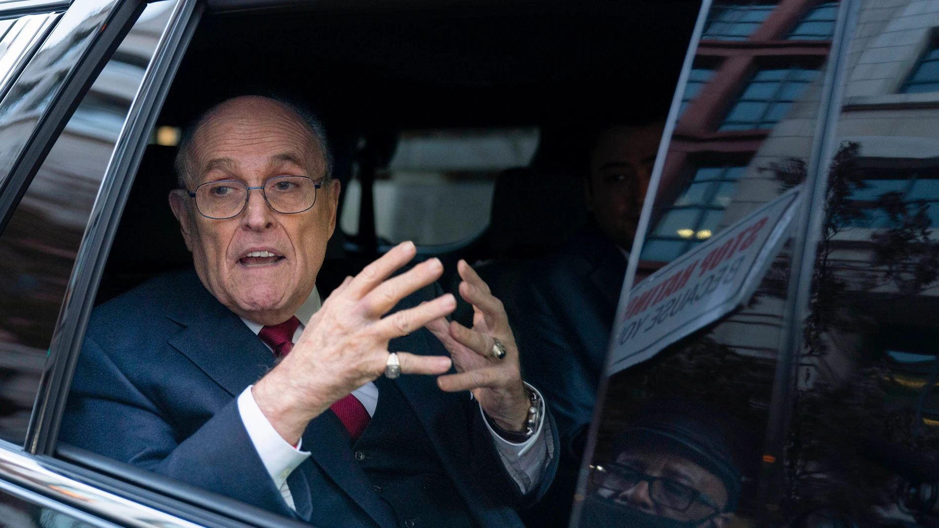 FILE - Former Mayor of New York Rudy Giuliani talks to reporters as he leaves after his defamation trial in Washington, Friday, Dec. 15, 2023. A jury awarded $148 million in damages on Friday to two former Georgia election workers who sued Giuliani for defamation over lies he spread about them in 2020 that upended their lives with racist threats and harassment. (AP Photo/Jose Luis Magana, File)