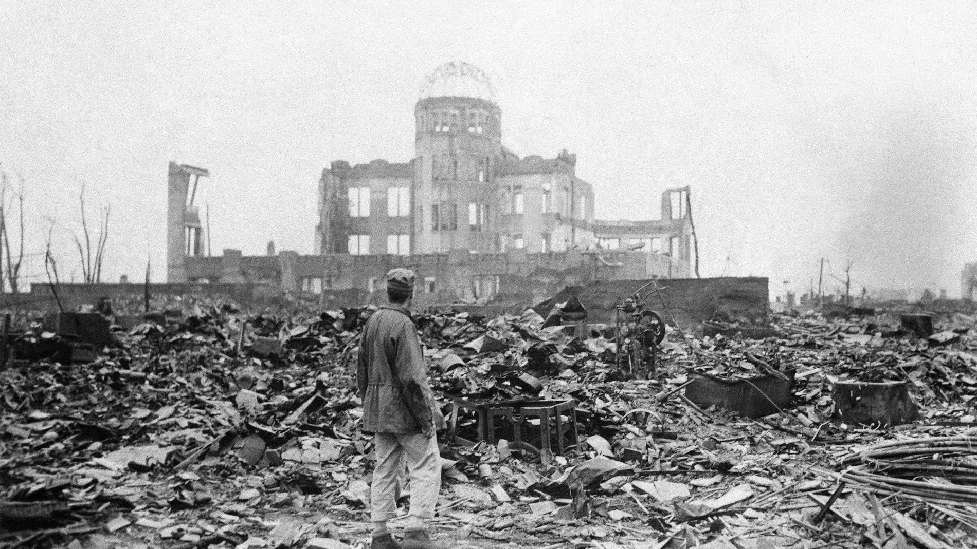 In this Sept. 8, 1945 file photo, an allied correspondent stands in the rubble in front of the shell of a building that once was a movie theater in Hiroshima, Japan, a month after the first atomic bomb ever used in warfare was dropped by the U.S. on Aug. 6, 1945