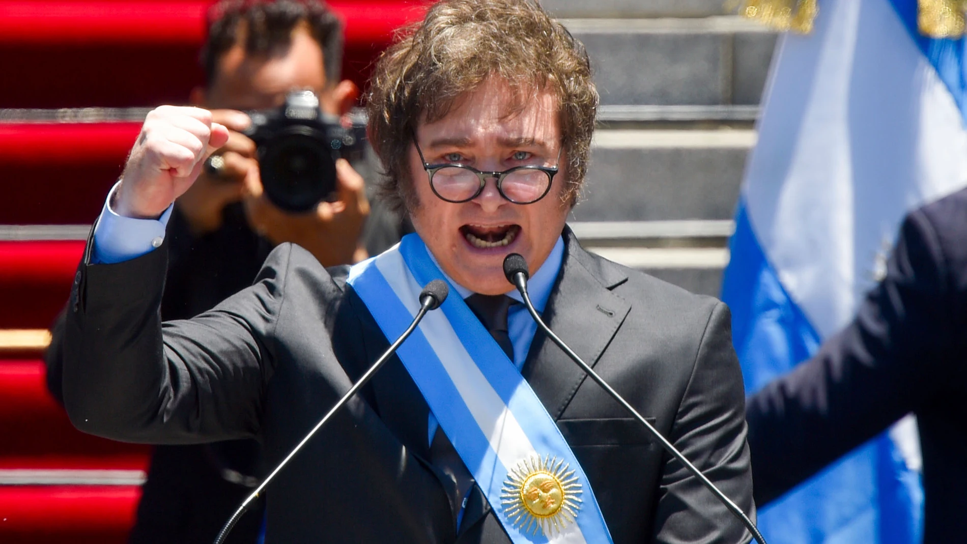 FILE- Argentina's newly sworn-in President Javier Milei speaks outside the Congress in Buenos Aires, Argentina, Dec. 10, 2023. Milei has drastically cut spending to end the fiscal deficit and contain inflation of almost 161% annually, including devaluing the peso more than 50%, dismissing public employees, suspending public works and reducing transportation and energy subsidies. (AP Photo/Gustavo Garello, File)