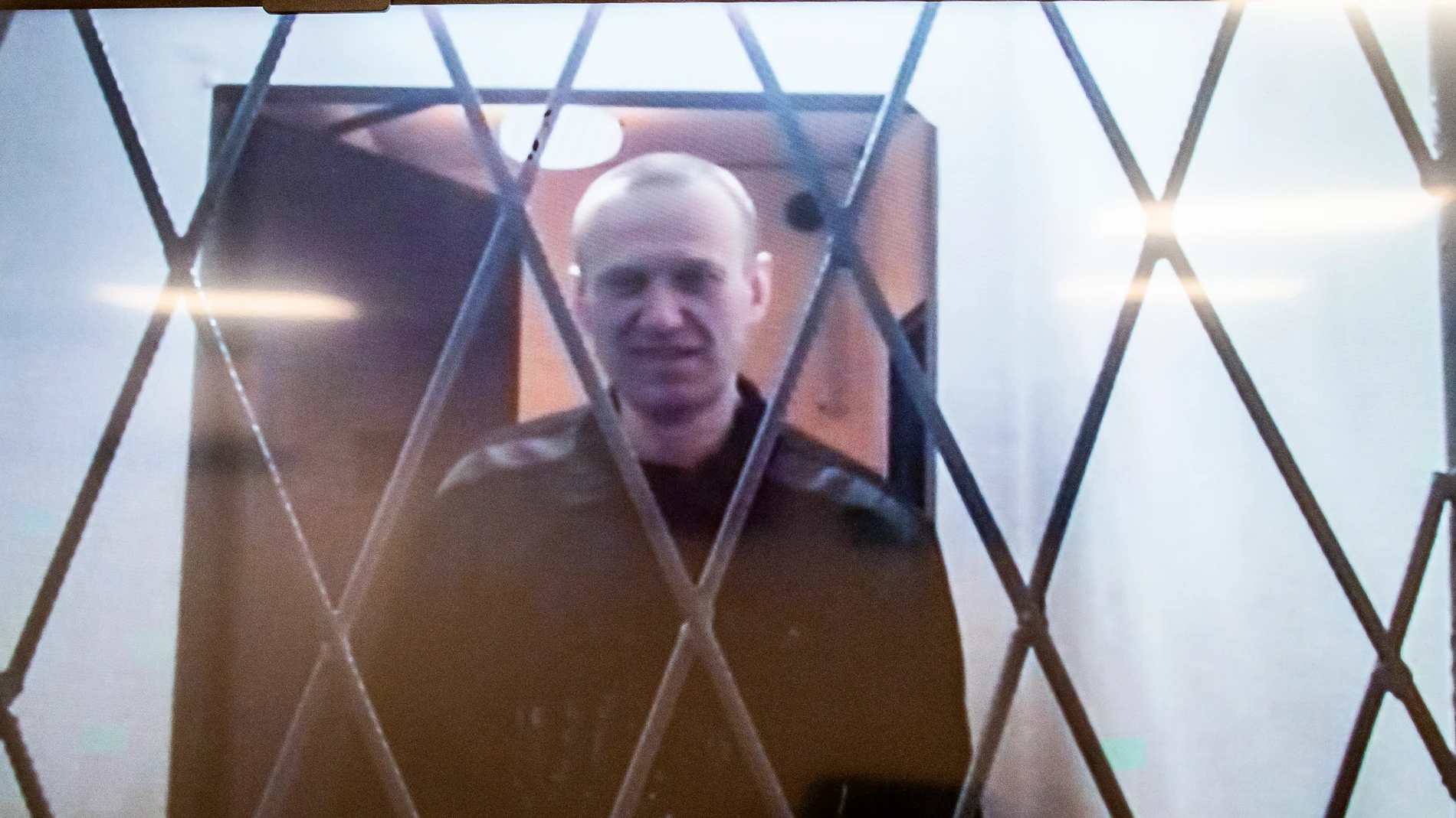 Russian opposition leader Alexei Navalny is seen on a TV screen as he appears in a video link provided by the Russian Federal Penitentiary Service from the courtroom in Kovrov, Vladimir region, about 240 kilometers (150 miles) east of Moscow, Russia, Wednesday, Jan. 10, 2024. Navalny, 47, is jailed on charges of extremism. He had been imprisoned in the Vladimir region of central Russia, but was transferred last month to a "special regime" penal colony — the highest security level of prisons i...