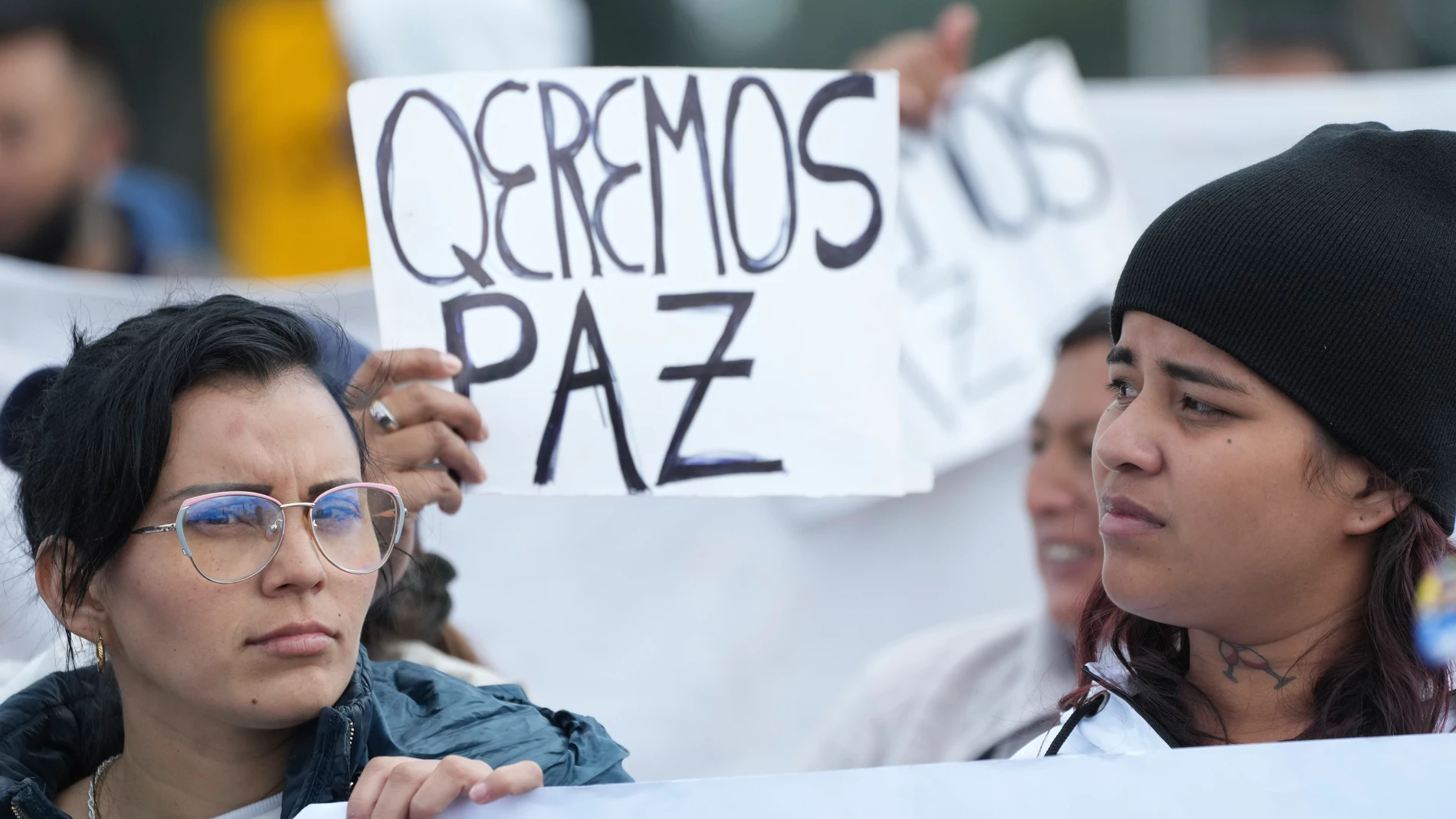Relatives of inmates hold signs asking for peace as they protest outside the Latacunga prison, officially known as the Center for Social Rehabilitation Regional Sierra, North Center, in Cotopaxi, Ecuador, Wednesday, Jan. 10, 2024. (AP Photo/Dolores Ochoa)